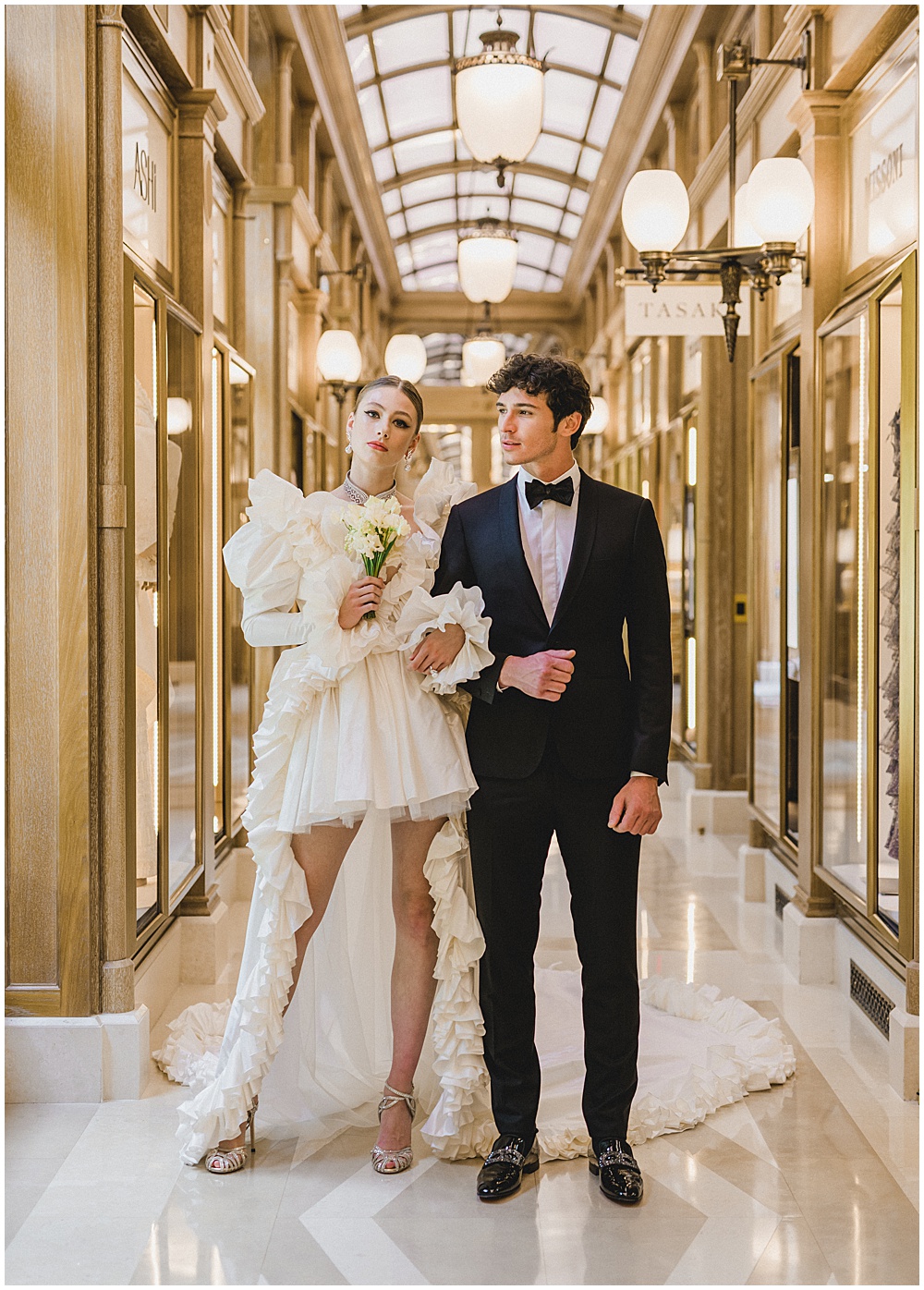 Luxury indoor couple portrait in a gold-toned gallery