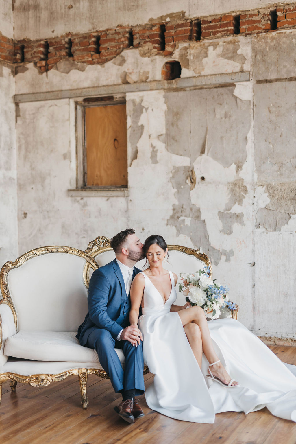 Vintage indoor couple moment on a gold and white sofa