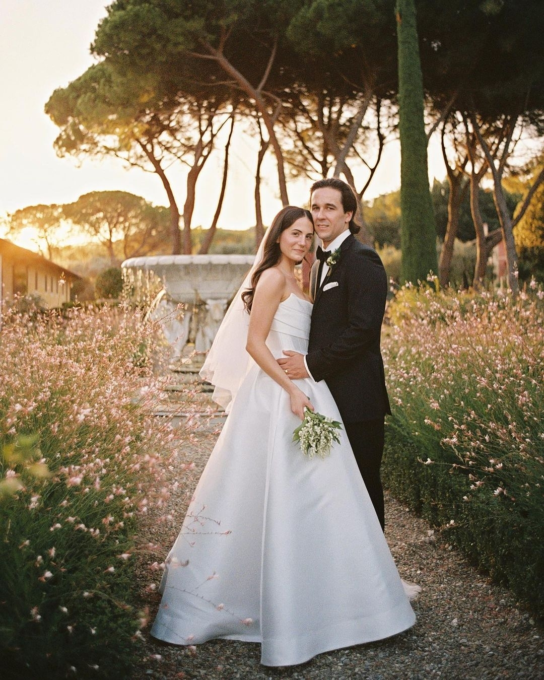 Romantic garden embrace at sunset surrounded by flowers