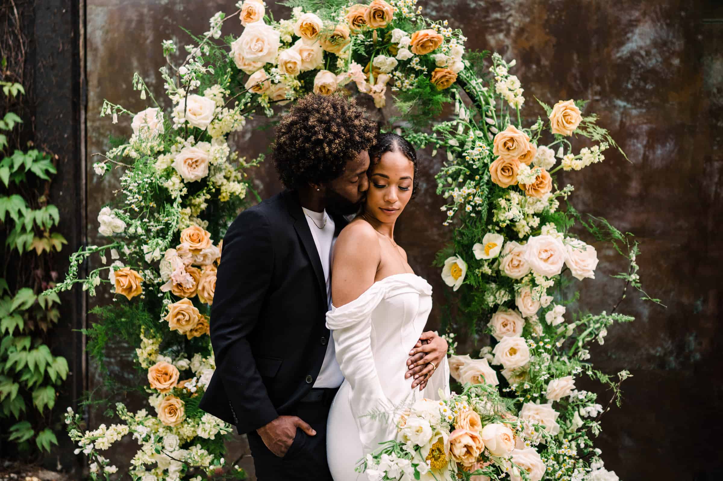Intimate floral-arch ceremony moment