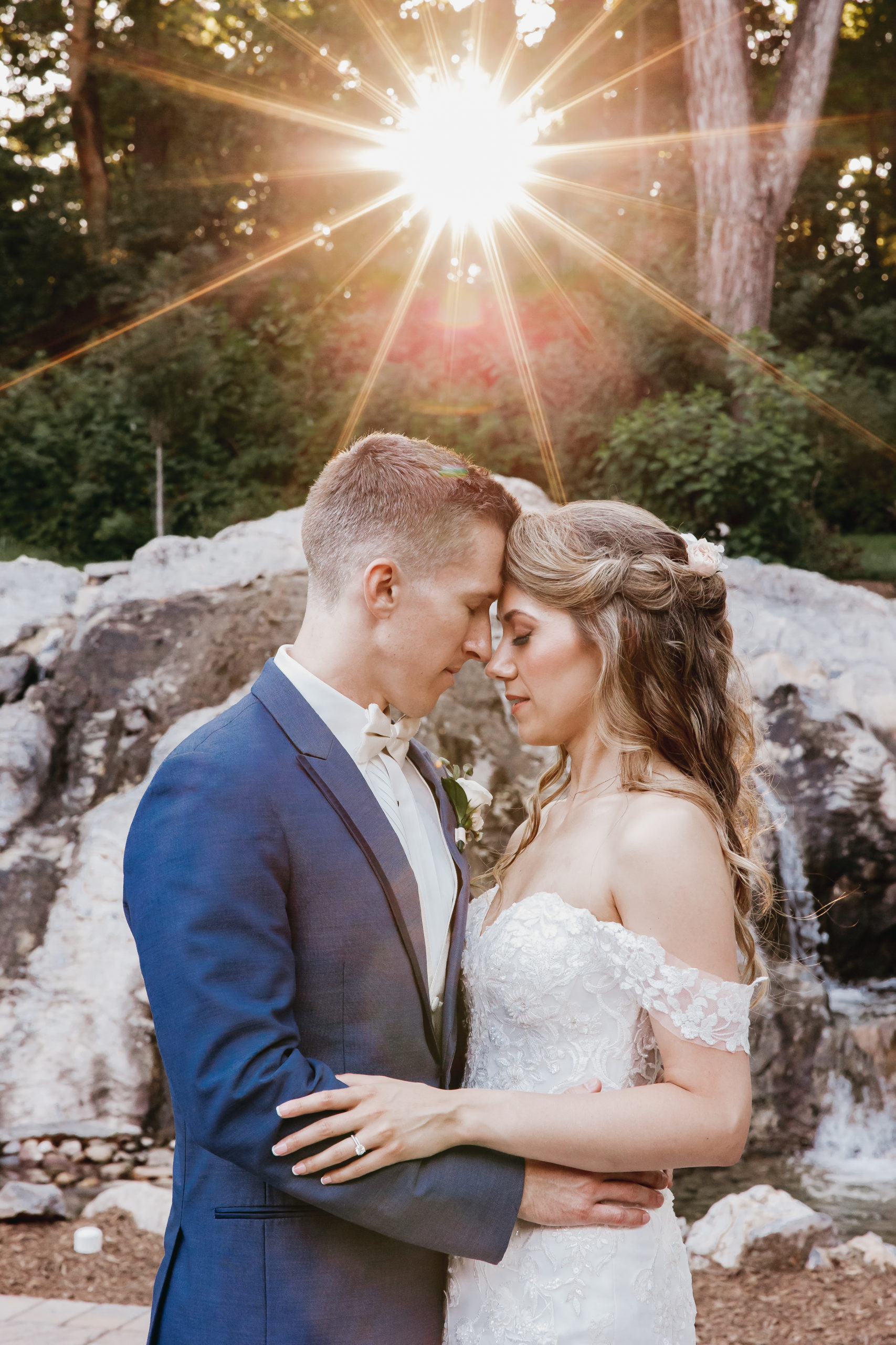 Sunlit outdoor couple portrait with golden flare