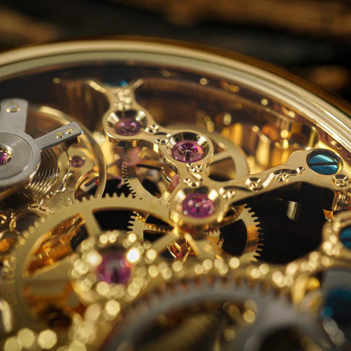 Macro view of golden watch mechanisms with purple rubies and blue accents